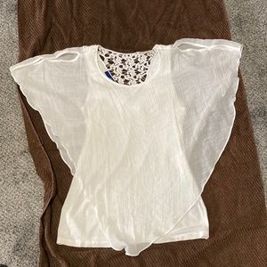White gauze top over a tank top with back lace inset at neck.